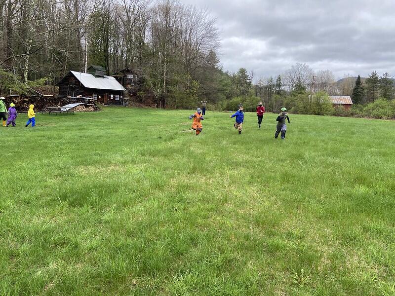students running across a field playing park ranger