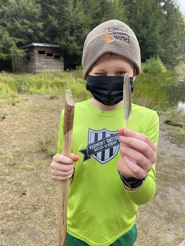 Student holding feather