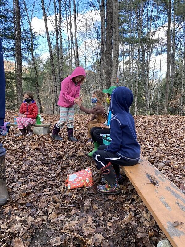 Student showing pet gerbil to friends