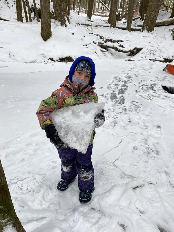 Student holding a big section of ice