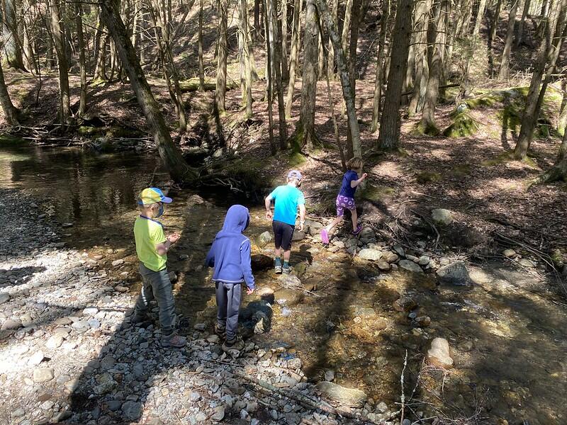 Students crossing the brook