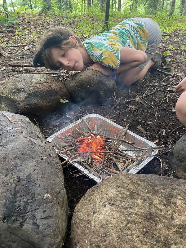 campers blowing on fire campers blowing on fire