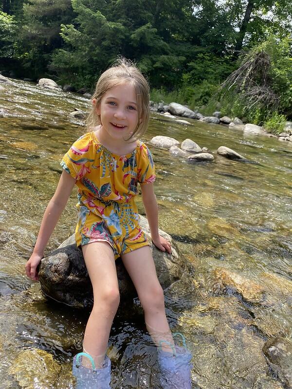 Camper on a rock at the River Camper on a rock at the River