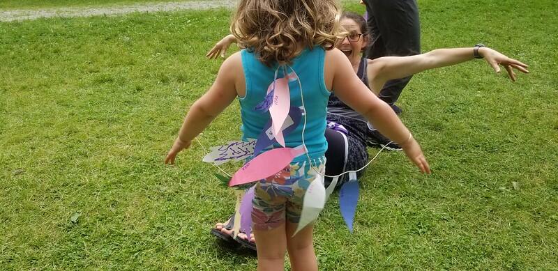 Camper with hand made bird wings flying to adult