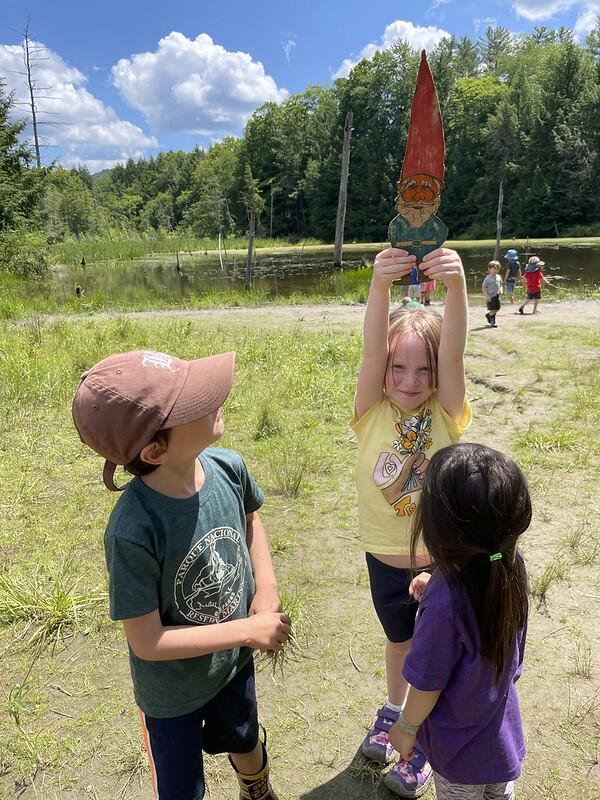 3 students with gnome at the pond