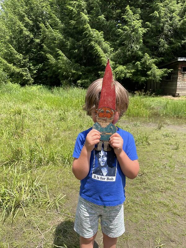 camper holding gnome over face