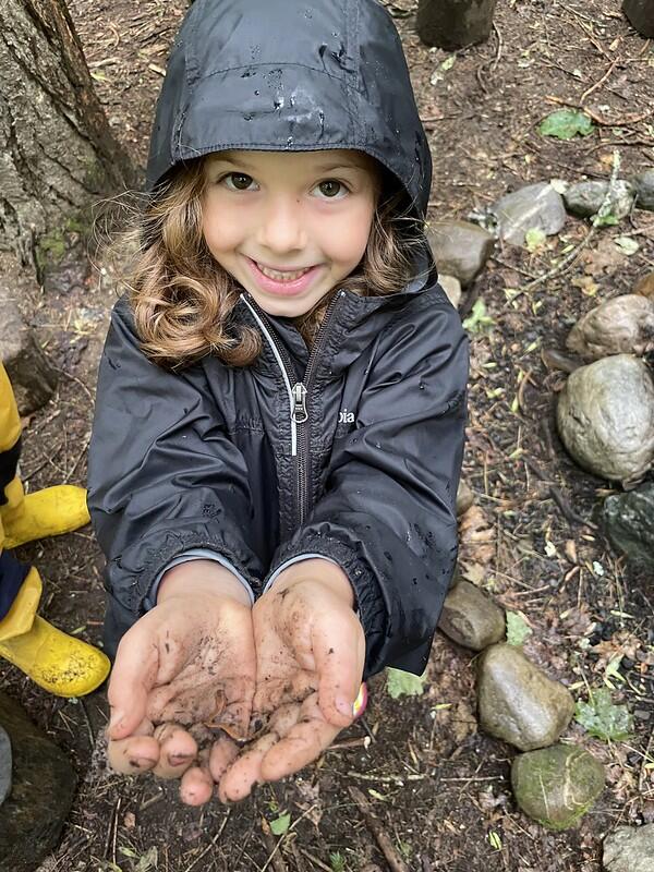 Camper with salamander in hand