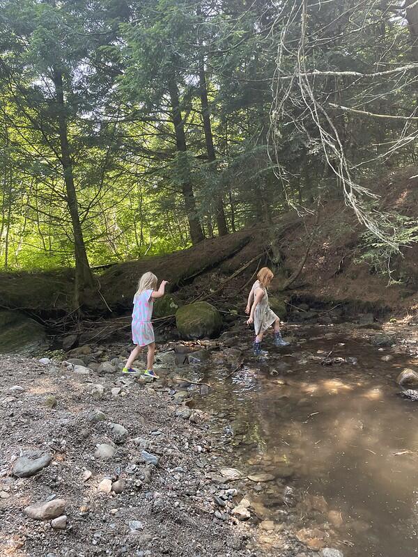 two campers exploring the brook