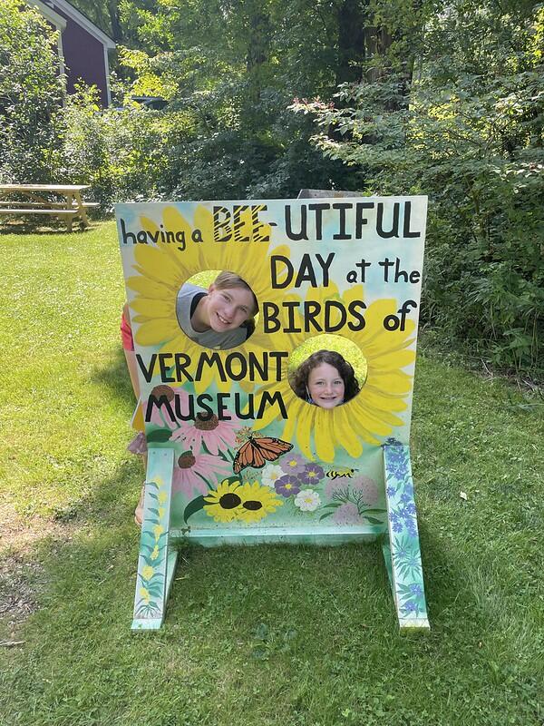 Two students in a cut out sign