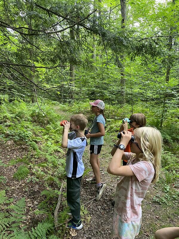 Campers bird watching with binoculars