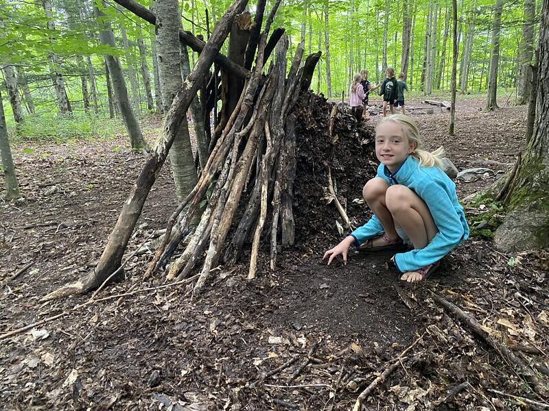 Student building a stick fort