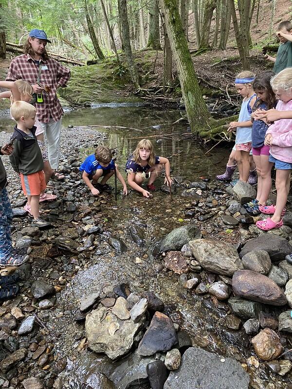 campers watching a tiny boat race