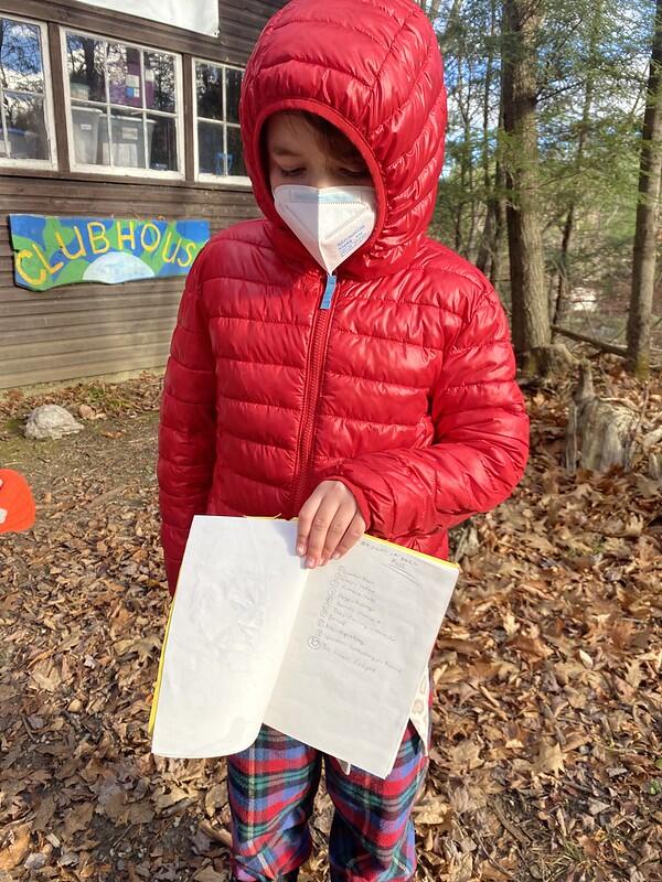 student holding nature notebook