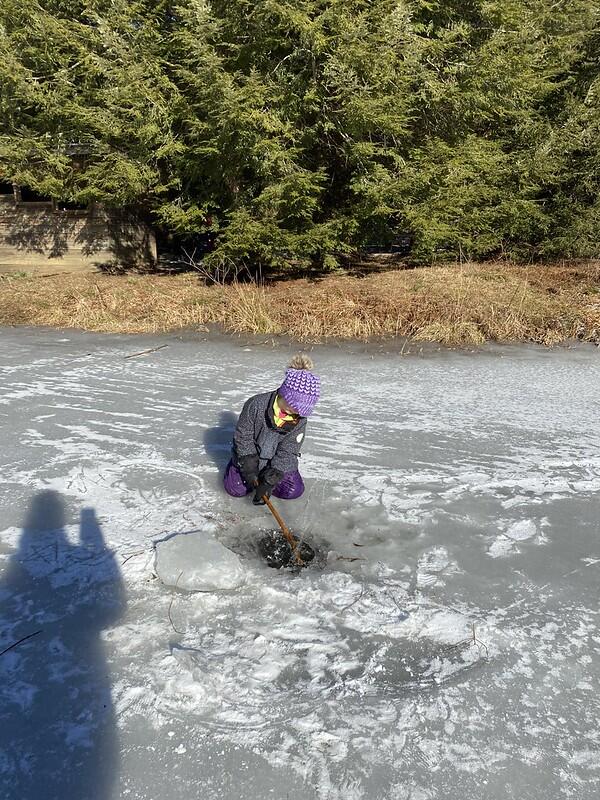 Student making a whole in the ice