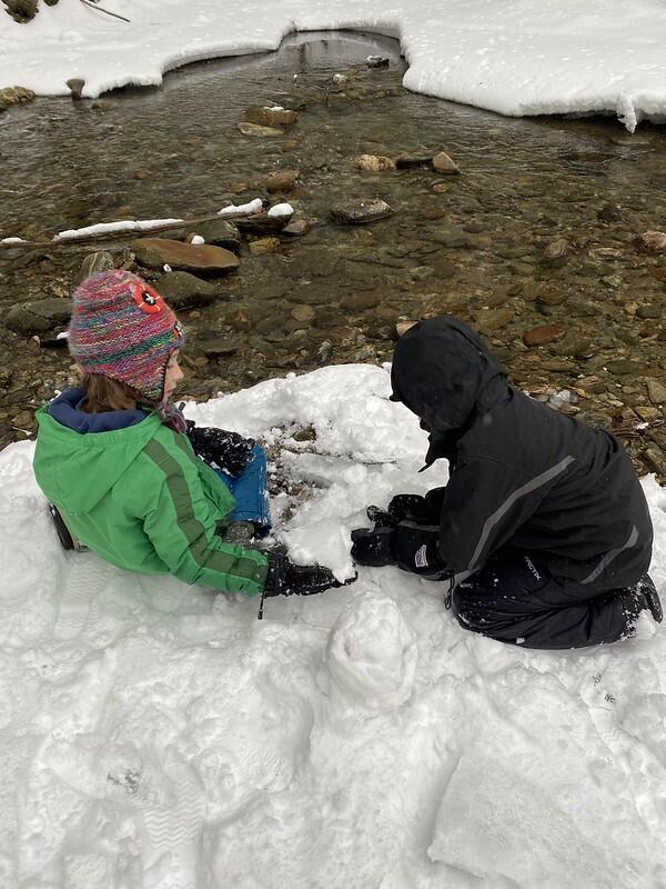 Two students at edge of brook