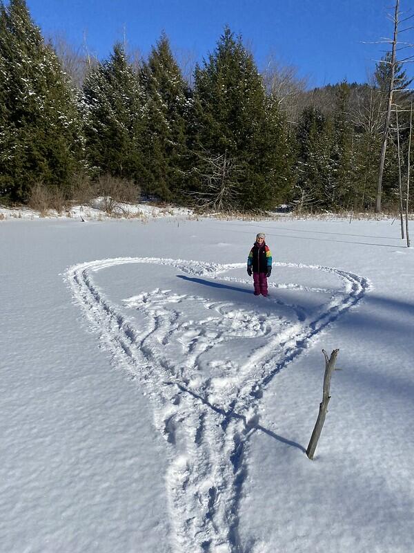 student next to snow art