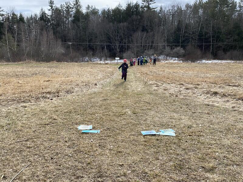 Students playing game at Peeper pond