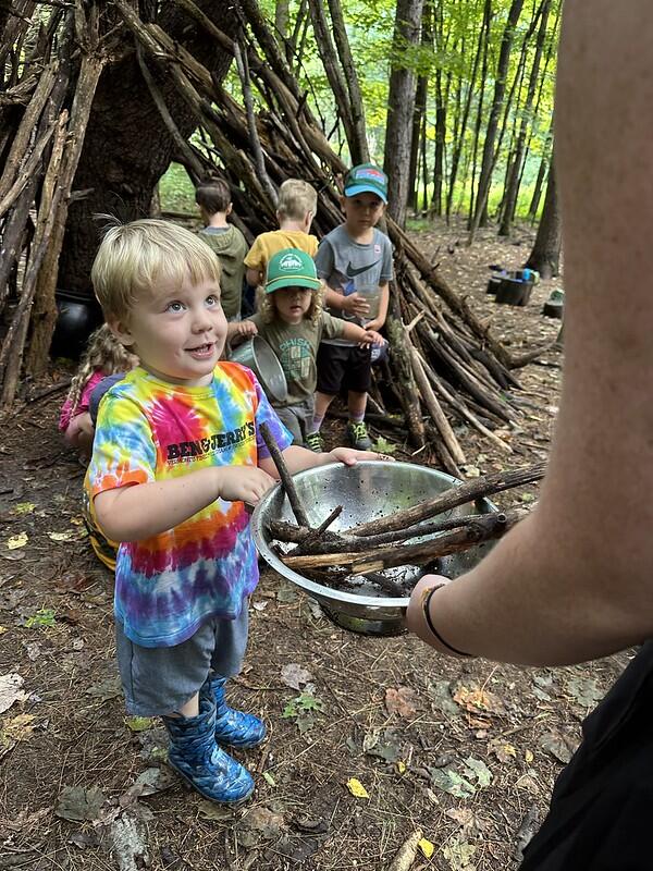 student in mud kitchen