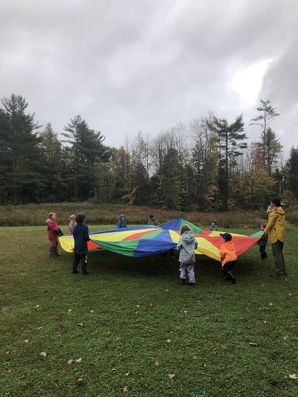 Group playing with a parachute