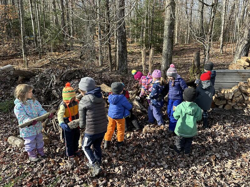 Students stacking wood