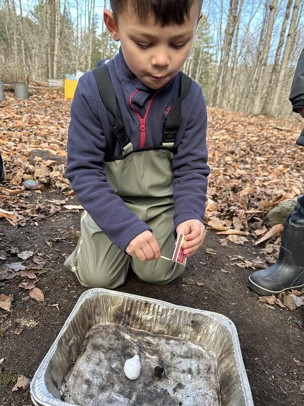 student lighting a match