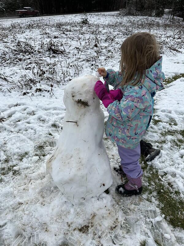 Student building a snow person
