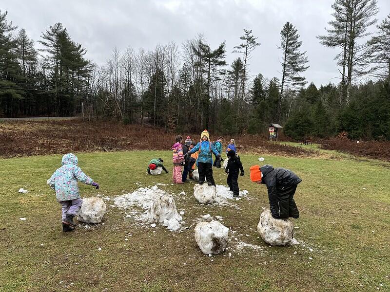 students standing on snowballs