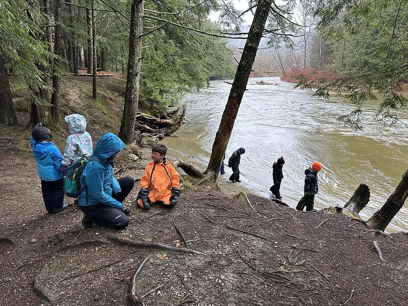 students exploring the river bank