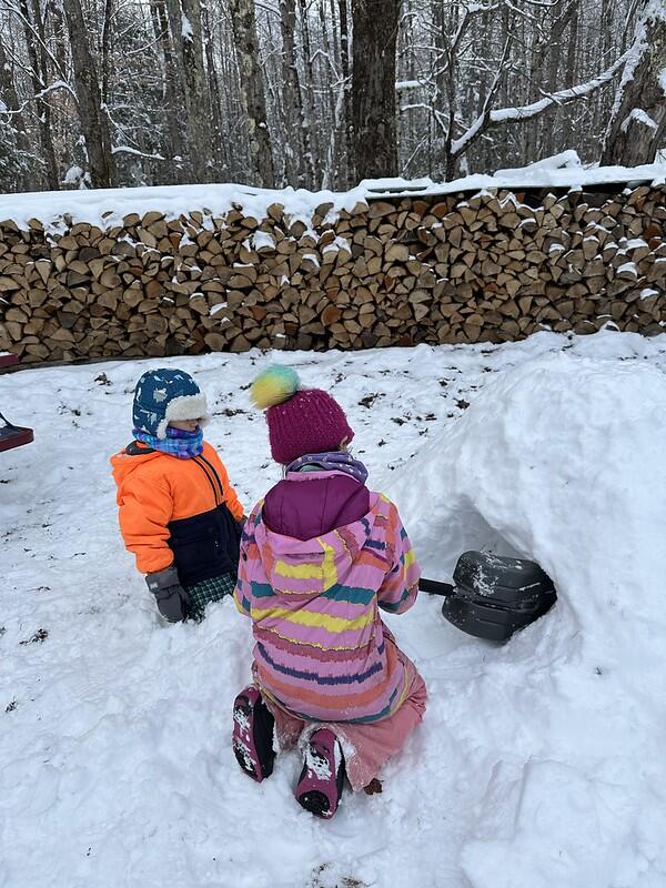 students digging out snow shelter
