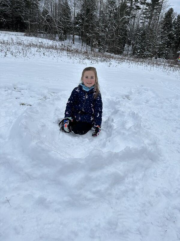 student in snow nest