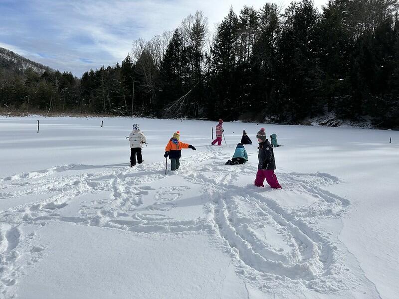 students on frozen beaver pond
