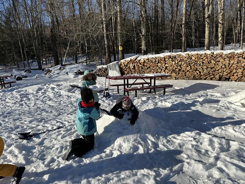 Students packing snow pile