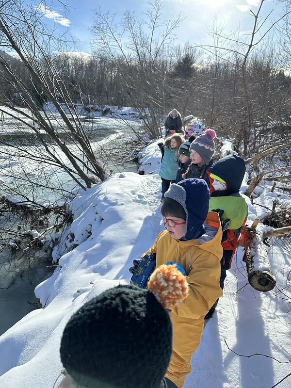Students standing by frozen river