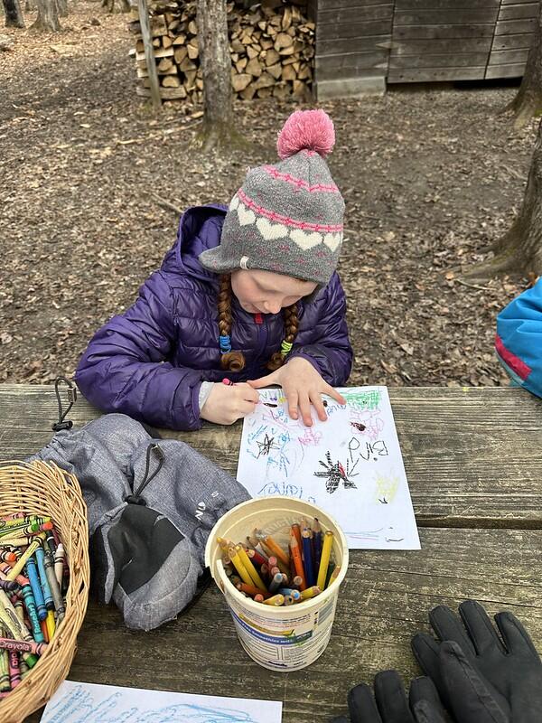 Student drawing a sign of spring