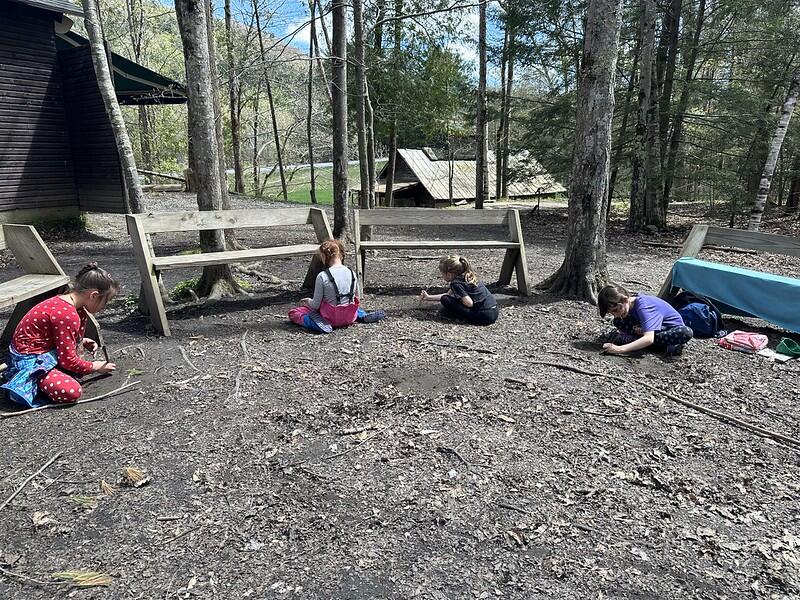 students writing on the ground