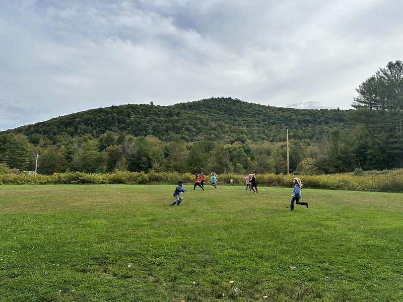 students running in the field students running in the field