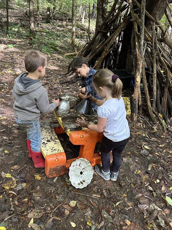 student in mud kitchen