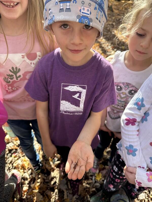 student holding red eft