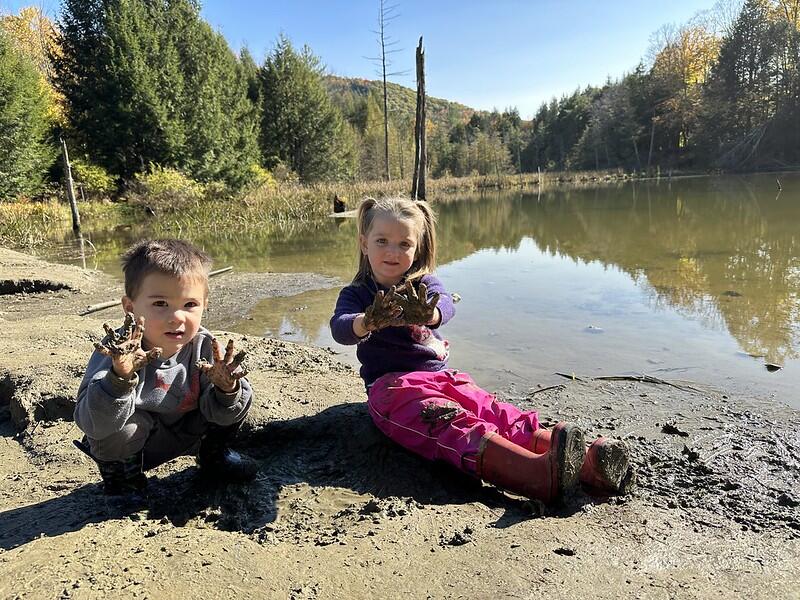 two students with muddy hands two students with muddy hands