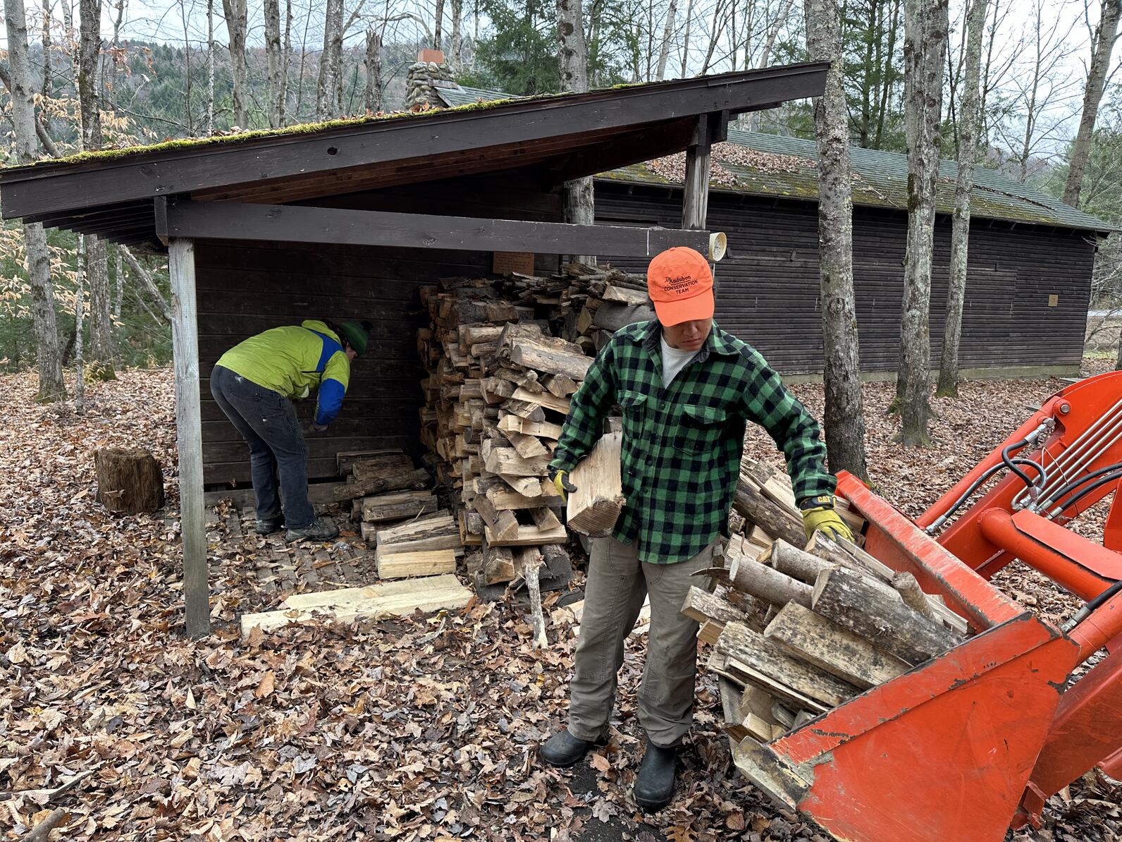 Audubon Vermont employees stack wood