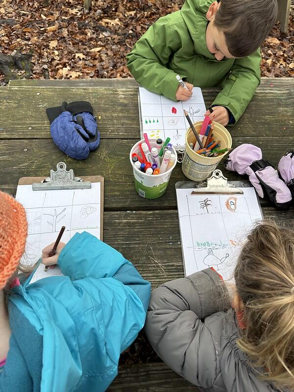 students drawing at picnic table