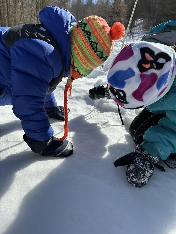students measuring the snow