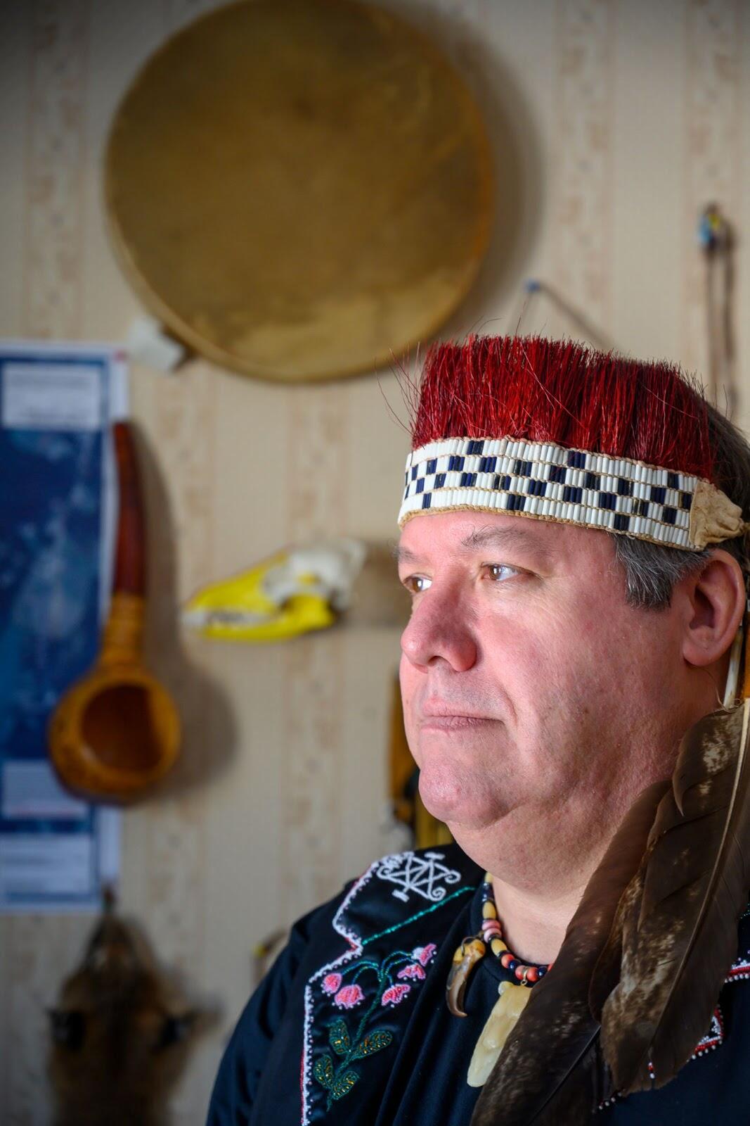 Chief Don Stevens of the Nulhegan Band of the Coosuk Abenaki Nation photographed in his home wearing traditional headdress and beaded necklace. Photo: Caleb Kenna Photography