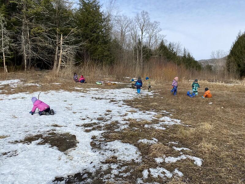 Children play in a snowy field