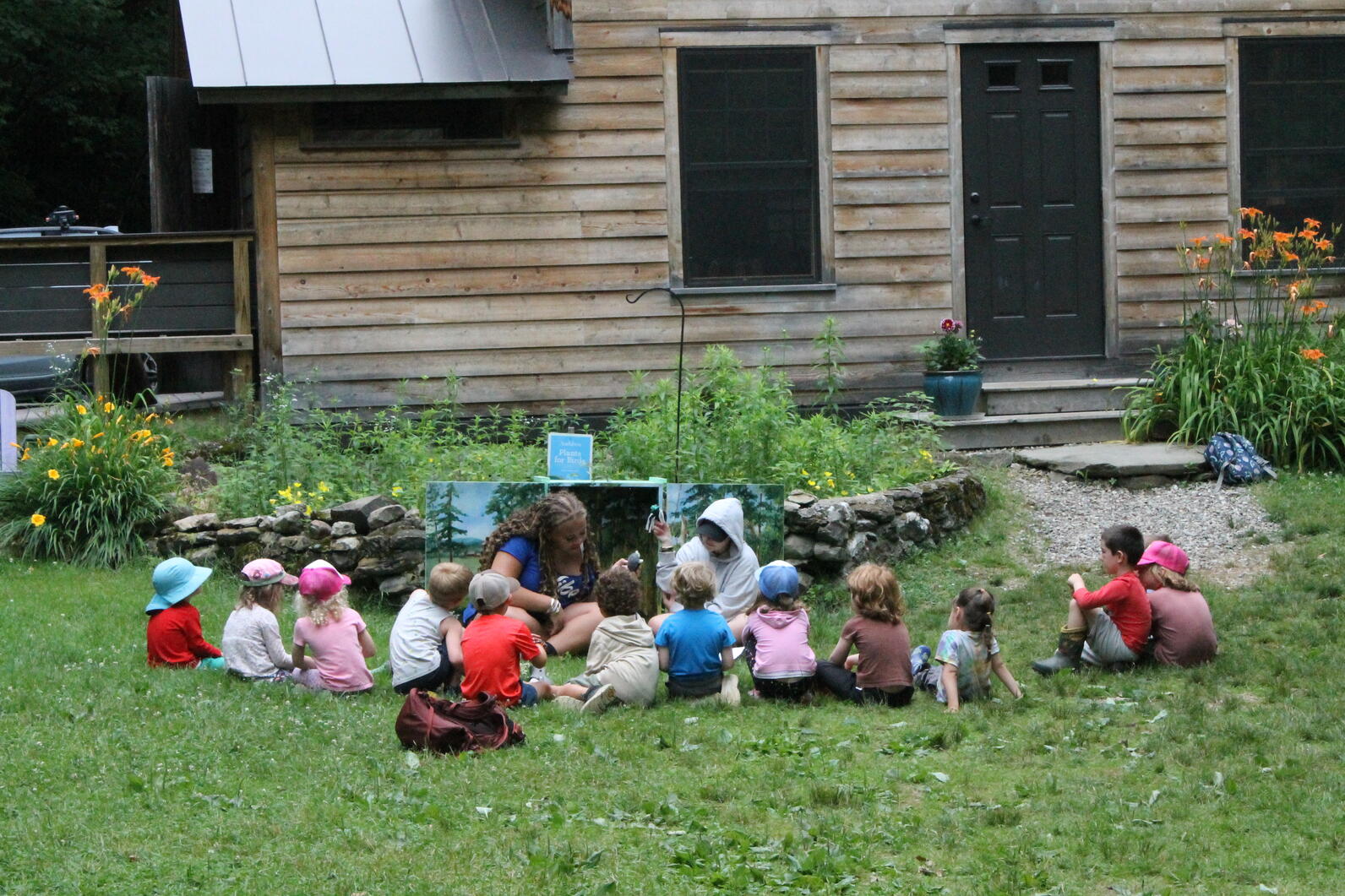 A CIT puts on a puppet show for campers.