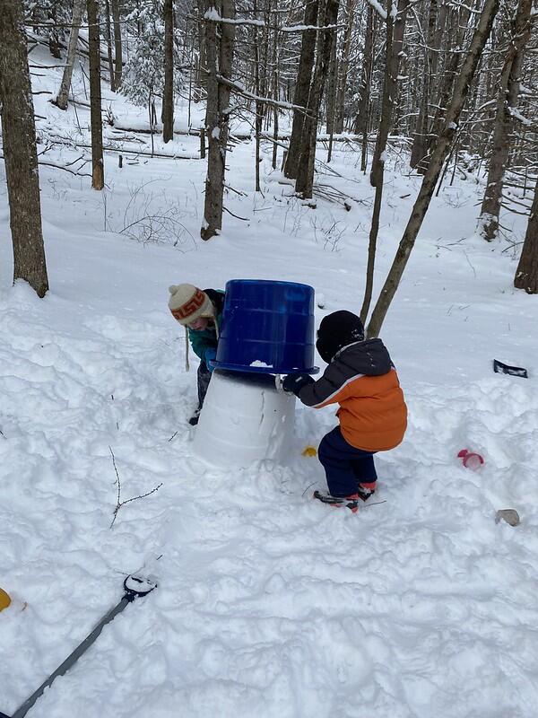 two children play in the snow