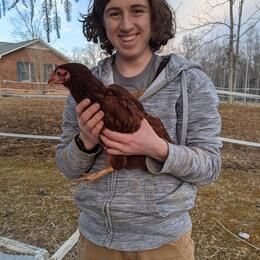 Carter Larsen holding a chicken.